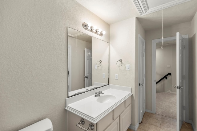 bathroom featuring vanity, tile patterned floors, and toilet