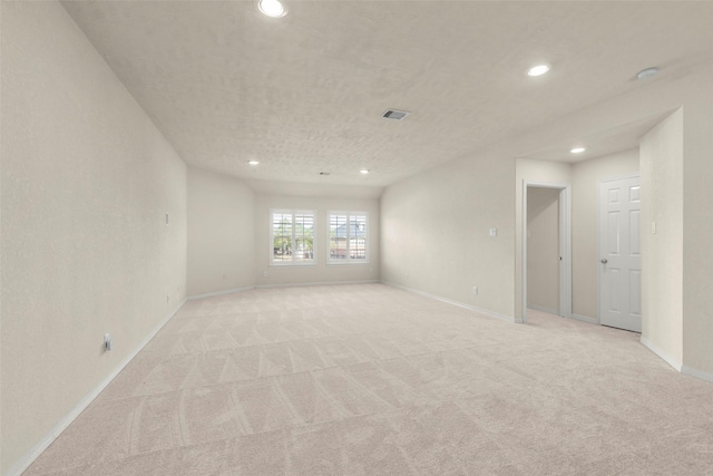 carpeted spare room featuring a textured ceiling