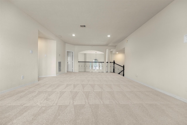 unfurnished living room with light colored carpet