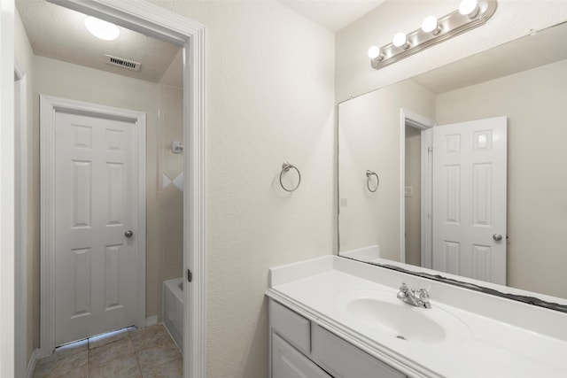 bathroom with tile patterned flooring and vanity