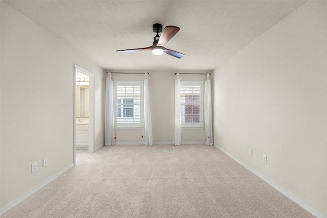 spare room featuring ceiling fan and light colored carpet