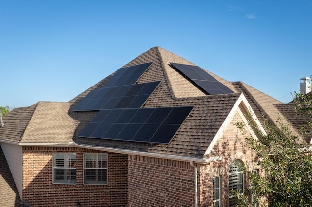 view of side of property with solar panels