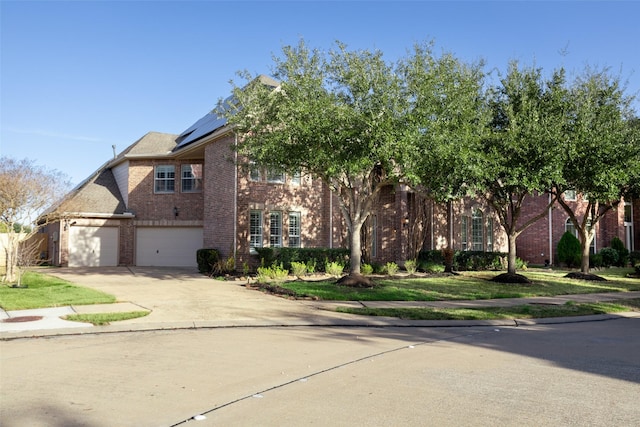 view of front of house featuring a garage and solar panels