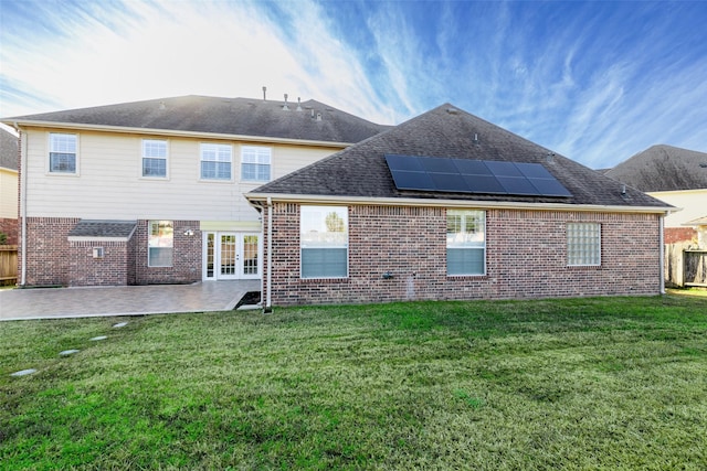 rear view of property with french doors, a yard, and a patio area