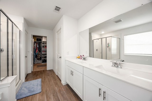 bathroom with vanity, hardwood / wood-style floors, and walk in shower