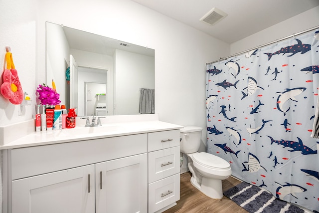 bathroom featuring vanity, hardwood / wood-style floors, curtained shower, and toilet