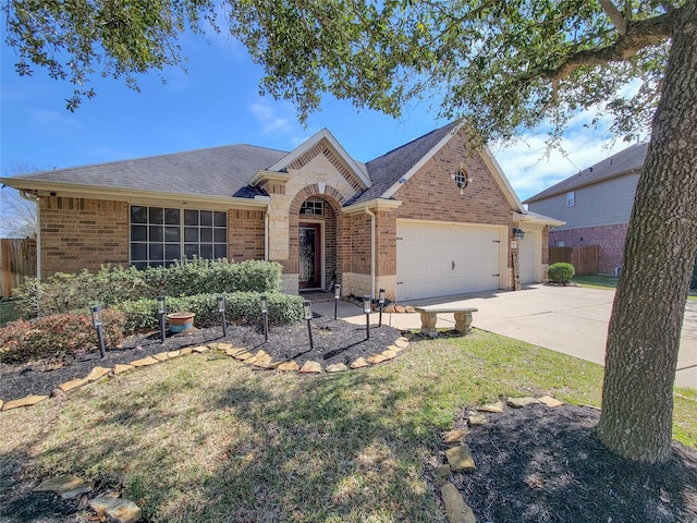 view of front of house featuring a garage, brick siding, driveway, and a front lawn