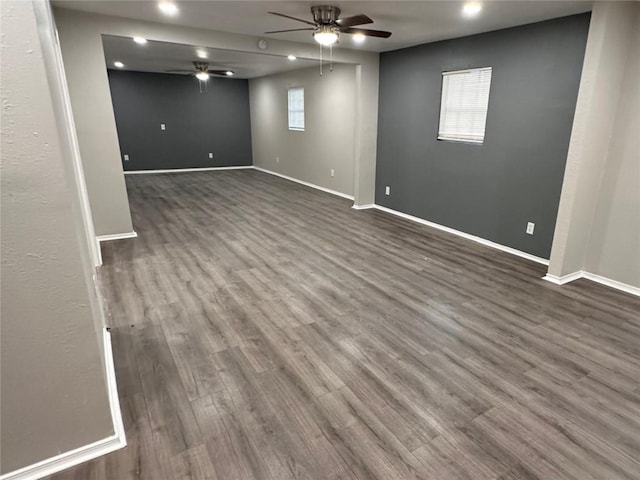 basement with recessed lighting, baseboards, ceiling fan, and dark wood-style flooring