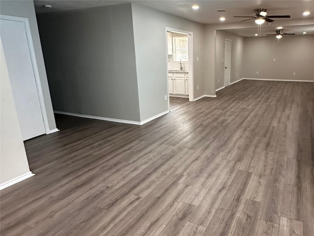 empty room featuring ceiling fan, dark hardwood / wood-style flooring, and sink