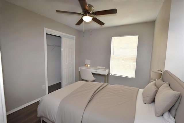 bedroom featuring a closet, dark wood finished floors, a ceiling fan, and baseboards