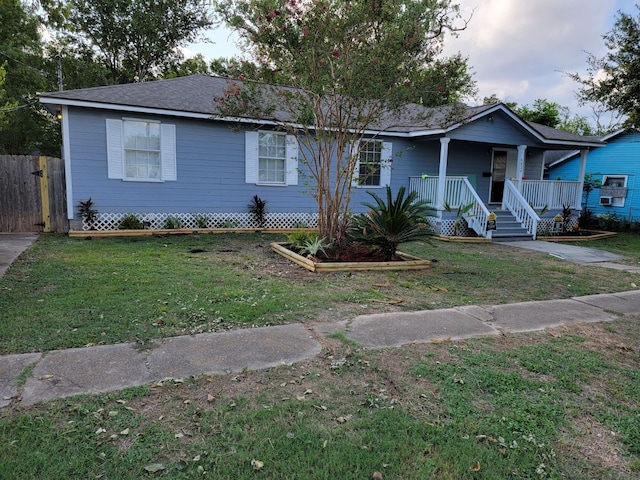 single story home with a front lawn and covered porch