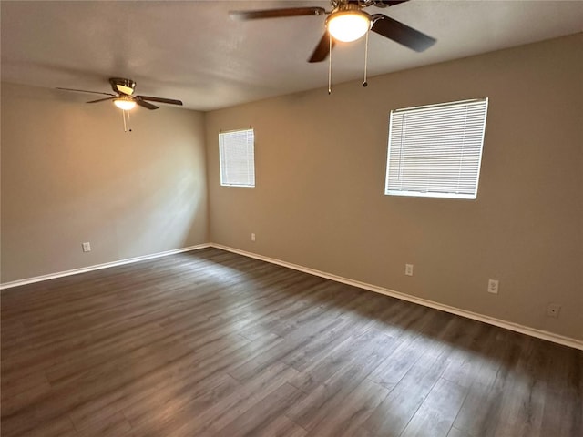 unfurnished room featuring dark wood-type flooring and ceiling fan