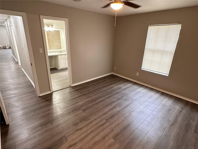 unfurnished room featuring dark hardwood / wood-style floors and ceiling fan