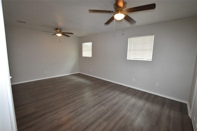 spare room featuring dark hardwood / wood-style floors and ceiling fan