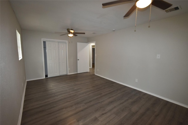 unfurnished room with ceiling fan and dark hardwood / wood-style flooring