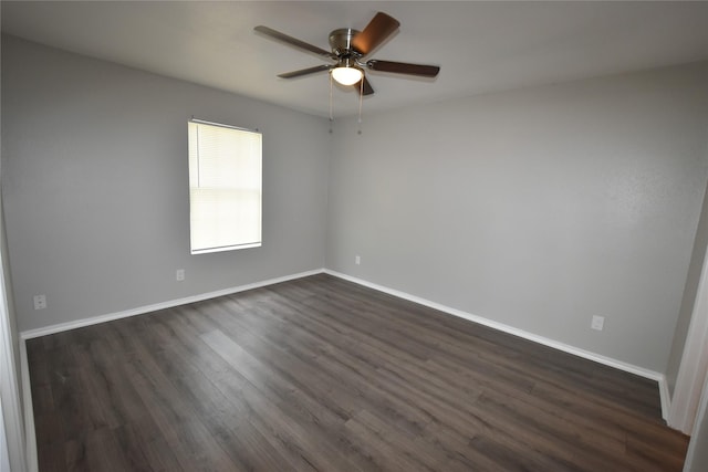 empty room with ceiling fan and dark hardwood / wood-style flooring