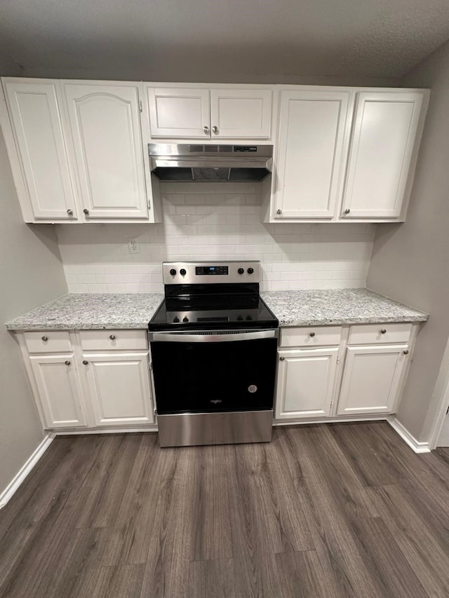 kitchen with dark wood-style floors, decorative backsplash, electric stove, under cabinet range hood, and white cabinetry