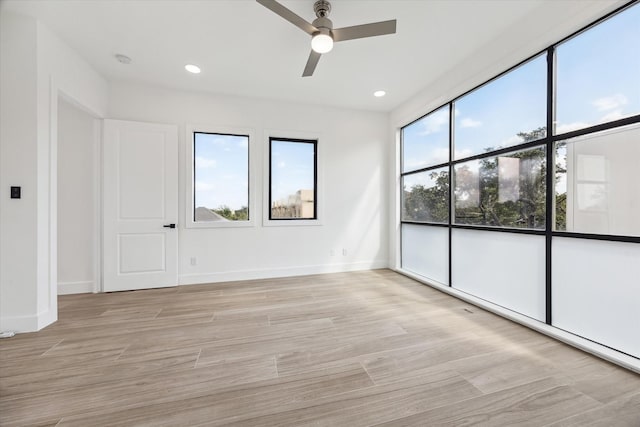 spare room with ceiling fan and light hardwood / wood-style floors