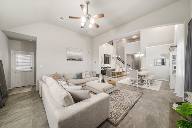 living room featuring ceiling fan with notable chandelier, visible vents, and high vaulted ceiling