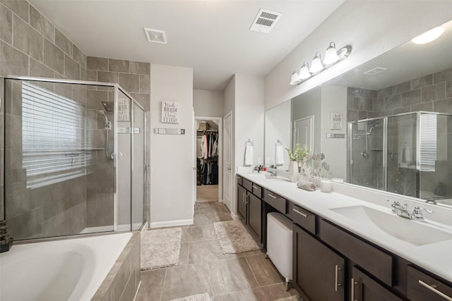 bathroom featuring a shower stall, a bath, visible vents, and a sink