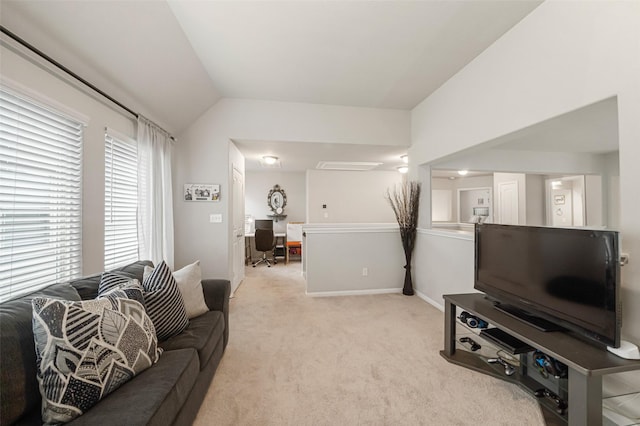 living area featuring light colored carpet, baseboards, and vaulted ceiling