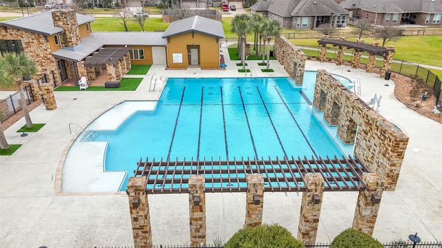 community pool with a residential view, a pergola, a patio, and fence