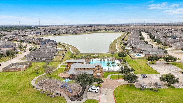 drone / aerial view with a residential view and a water view