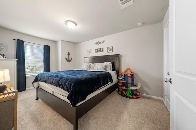 carpeted bedroom featuring baseboards and visible vents