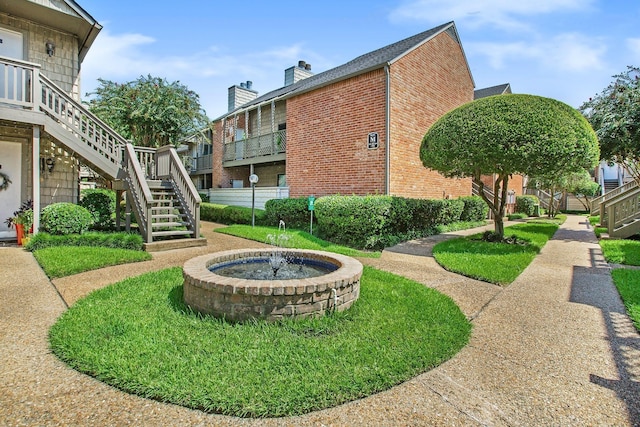 view of home's community with a yard