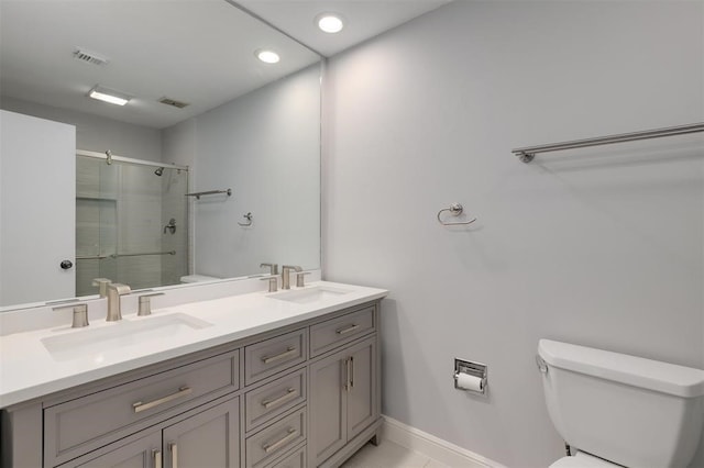 bathroom with vanity, toilet, and walk in shower