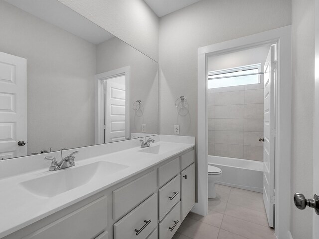 29651 Bur Creek Ln, Fulshear, TX 77441 - bathroom featuring toilet, double vanity, tile patterned flooring, and tub / shower combination