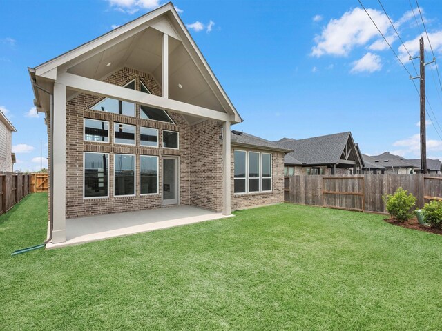 29651 Bur Creek Ln, Fulshear, TX 77441 - back of house featuring brick siding and a patio area