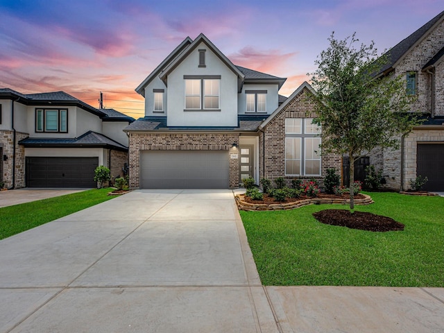 29651 Bur Creek Ln, Fulshear, TX 77441 - view of front facade with an attached garage, stucco siding, concrete driveway, a yard, and brick siding
