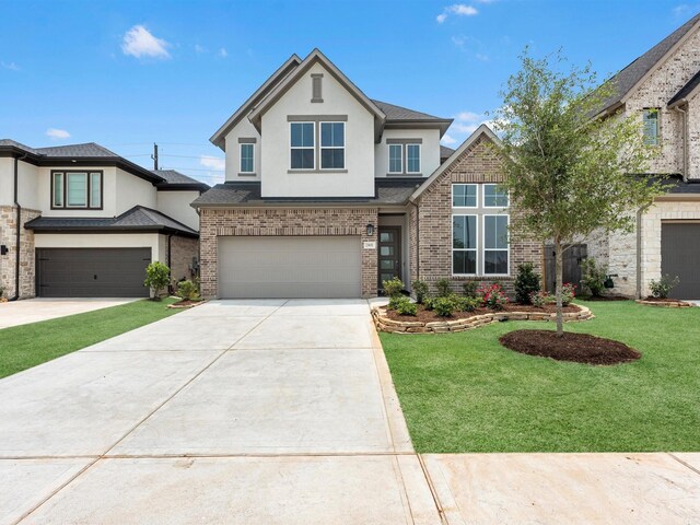 29651 Bur Creek Ln, Fulshear, TX 77441 - view of front of property featuring a garage, concrete driveway, stucco siding, and brick siding