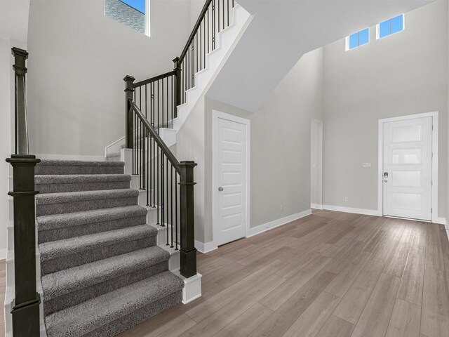 29651 Bur Creek Ln, Fulshear, TX 77441 - stairs with a high ceiling, plenty of natural light, wood finished floors, and baseboards