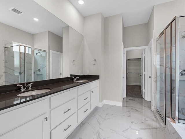 29651 Bur Creek Ln, Fulshear, TX 77441 - bathroom featuring a marble finish shower, baseboards, marble finish floors, double vanity, and a spacious closet