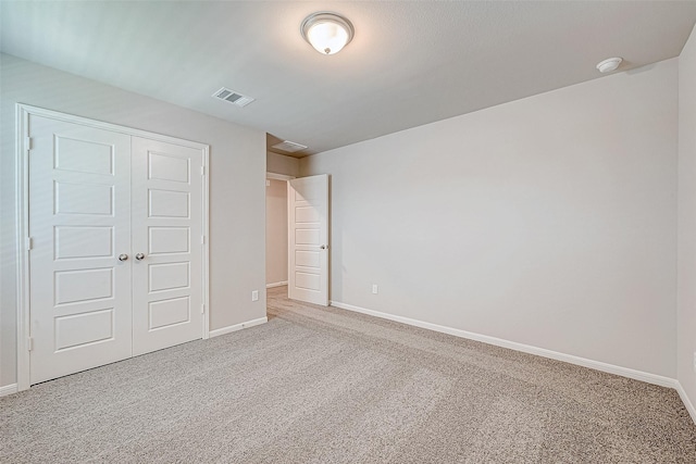 unfurnished bedroom with carpet floors and a closet