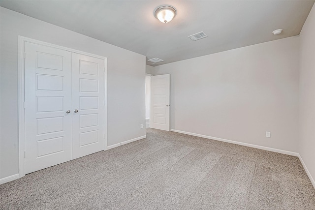 unfurnished bedroom featuring carpet floors and a closet