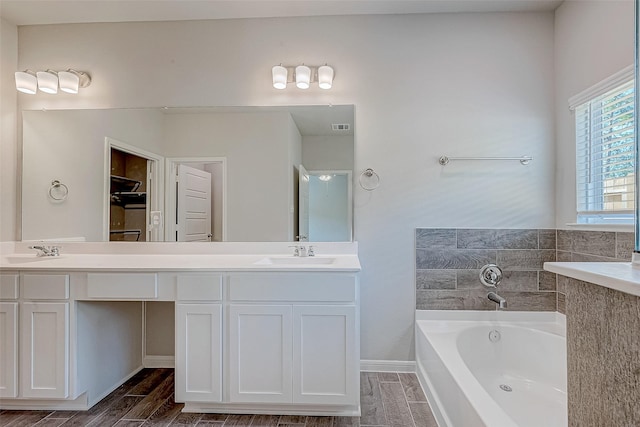 bathroom with vanity and a bath