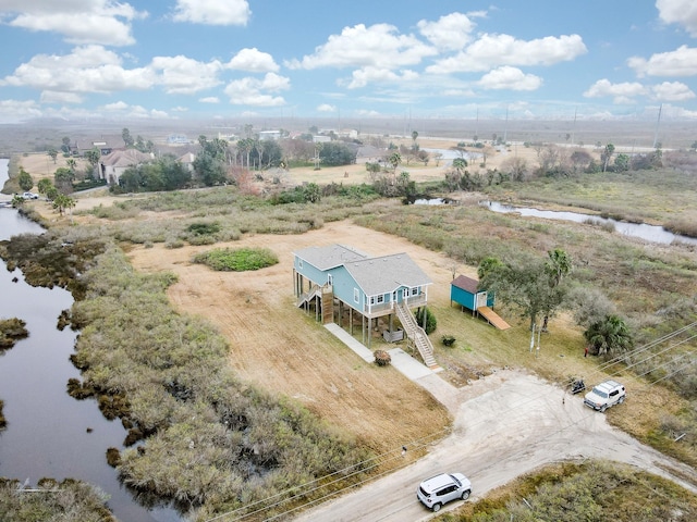 birds eye view of property with a water view and a rural view