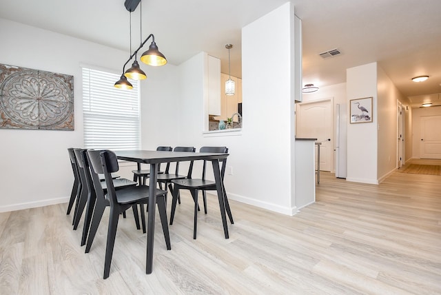 dining space with light wood-type flooring