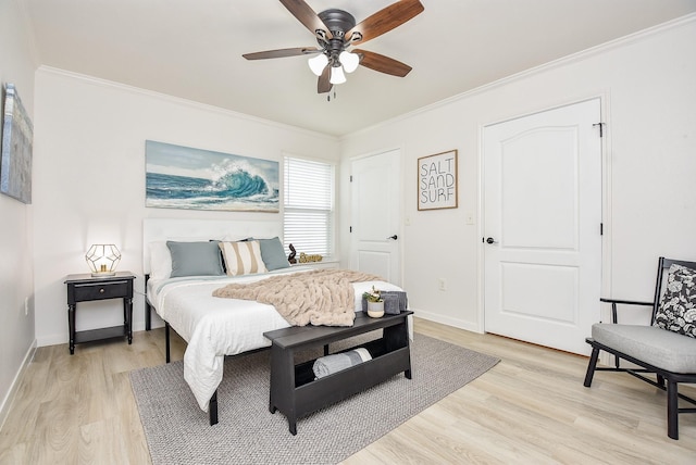 bedroom with crown molding, ceiling fan, and light hardwood / wood-style floors