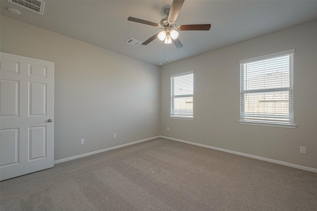 carpeted spare room featuring ceiling fan