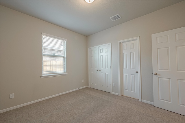 unfurnished bedroom with light carpet