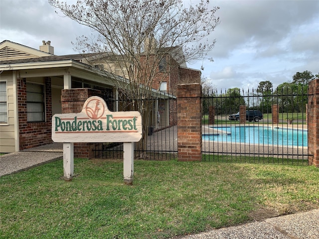 community / neighborhood sign with a lawn