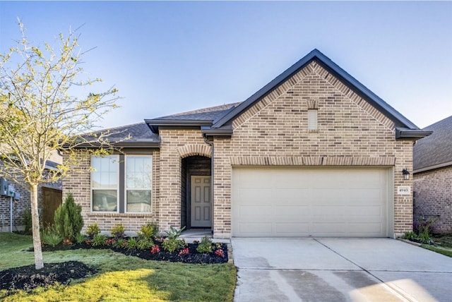 view of front of property with a garage and a front lawn