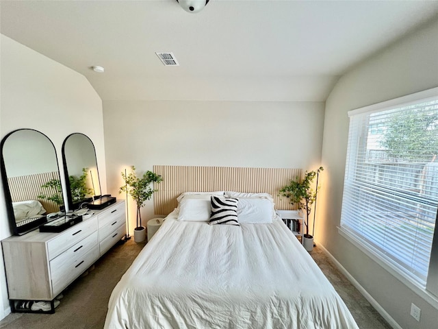 carpeted bedroom with lofted ceiling