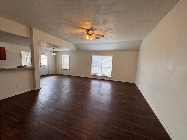 empty room with dark wood-type flooring, ceiling fan, and a textured ceiling