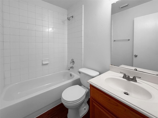 bathroom featuring shower / washtub combination, visible vents, toilet, vanity, and wood finished floors