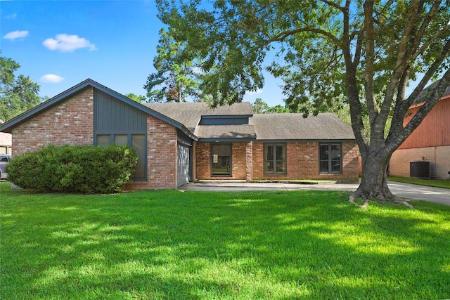 ranch-style house with cooling unit and a front lawn